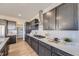 Spacious kitchen with dark cabinets, a gas range, and stainless steel appliances at 4096 Estrella St, Brighton, CO 80601