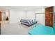 Spacious basement bedroom featuring a bed, workout equipment, and closet access at 6565 W 99Th Ave, Broomfield, CO 80021
