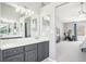 A spacious bathroom featuring dual vanities, a walk-through design, and a bright, airy atmosphere at 6565 W 99Th Ave, Broomfield, CO 80021