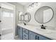 Modern bathroom with double sinks, round mirrors, and stylish vanity lighting at 6565 W 99Th Ave, Broomfield, CO 80021