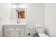 Bright bathroom featuring a single sink vanity with chrome hardware and a framed mirror at 6565 W 99Th Ave, Broomfield, CO 80021