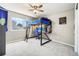 Cozy bedroom featuring a window view, carpeted floor, and loft bed with desk space at 6565 W 99Th Ave, Broomfield, CO 80021