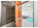 Bedroom with a striped comforter on the bed and a view of the shower with glass doors at 6565 W 99Th Ave, Broomfield, CO 80021
