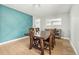 Dining room with a rustic wood table, modern light fixture, and accent wall at 6565 W 99Th Ave, Broomfield, CO 80021