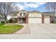 Charming two-story home featuring a three-car garage, brick accents, and a beautifully landscaped front yard at 6565 W 99Th Ave, Broomfield, CO 80021