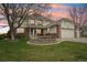 Charming two-story home featuring brick accents, a well-kept lawn, and a two-car garage at 6565 W 99Th Ave, Broomfield, CO 80021