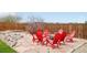 Cozy backyard fire pit area with red Adirondack chairs and stone pavers at 6565 W 99Th Ave, Broomfield, CO 80021