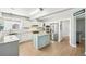 Bright kitchen features stainless steel appliances, white cabinets, granite countertops, and a center island at 6565 W 99Th Ave, Broomfield, CO 80021
