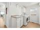 Well-lit laundry room with sink, cabinets and modern washer and dryer at 6565 W 99Th Ave, Broomfield, CO 80021