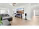 Bright living room features a large TV, wood floors, and a comfortable gray sectional sofa at 6565 W 99Th Ave, Broomfield, CO 80021