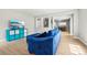 Bright living room features light-colored wood flooring and a comfortable blue sofa at 6565 W 99Th Ave, Broomfield, CO 80021
