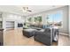 Bright living room with a large gray sectional sofa, fireplace, and large windows for natural light at 6565 W 99Th Ave, Broomfield, CO 80021