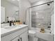 Neutral bathroom featuring shower and tub combination and vanity with quartz countertop and matte black hardware at 2225 S Poppy St, Lakewood, CO 80228