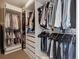 Organized walk-in closet featuring ample storage with built-in shelving and hanging space at 2225 S Poppy St, Lakewood, CO 80228