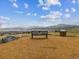 Community view with a bench overlooking a field and distant mountains on a cloudy day at 2225 S Poppy St, Lakewood, CO 80228