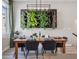 Stylish dining area with a modern light fixture and a unique wall-mounted vertical garden feature at 2225 S Poppy St, Lakewood, CO 80228