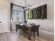Dining area features a vertical plant art piece, modern lighting and seating for six at 2225 S Poppy St, Lakewood, CO 80228