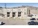 Modern townhomes with a combination of neutral siding and brick, multiple windows and a mountain view backdrop at 2225 S Poppy St, Lakewood, CO 80228