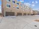 Row of private garages, each complementing the home's exterior, with modern doors and ample driveway space at 2225 S Poppy St, Lakewood, CO 80228