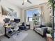 Bright home office with a modern desk, ergonomic chair, and a comfortable seating area at 2225 S Poppy St, Lakewood, CO 80228
