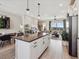 Kitchen with island seating flowing to the dining room and balcony with a view at 2225 S Poppy St, Lakewood, CO 80228