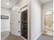 Functional laundry area in hall with a stacked washer and dryer for space-saving convenience at 2225 S Poppy St, Lakewood, CO 80228