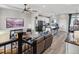 Open living space with stairs, leading into a kitchen featuring modern design and wood floors at 2225 S Poppy St, Lakewood, CO 80228