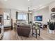 Bright living room featuring wood floors, a ceiling fan, comfortable seating, and a view of the balcony at 2225 S Poppy St, Lakewood, CO 80228