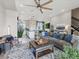 Bright open living room features a ceiling fan, neutral colors, and flows into the kitchen area at 2225 S Poppy St, Lakewood, CO 80228