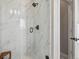 Elegant shower with marble-look tile and modern fixtures, showcasing a luxurious bathing space at 2225 S Poppy St, Lakewood, CO 80228