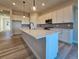 Bright kitchen featuring a large center island with white countertops, stylish cabinets, and modern stainless steel appliances at 5930 S Platte Canyon Dr, Littleton, CO 80123