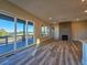 Open-concept living room with hardwood floors, a fireplace, and large sliding glass doors leading to the outdoor patio at 5930 S Platte Canyon Dr, Littleton, CO 80123