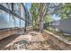 Landscaped backyard with mature trees and a stone retaining wall at 1050 N Corona St # 207, Denver, CO 80218