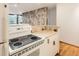 White appliances and cabinetry in this galley kitchen at 1050 N Corona St # 207, Denver, CO 80218