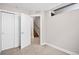 Bedroom with a closet, adjacent stairway, and neutral carpet and paint creating a cozy space at 3735 Kalamath St # 3, Denver, CO 80211