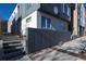 Modern townhome exterior featuring concrete steps, gray siding, and contemporary landscaping accents at 3735 Kalamath St # 3, Denver, CO 80211