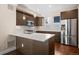 Modern kitchen with dark wood cabinets, stainless steel appliances, white countertops, and a stylish backsplash at 3735 Kalamath St # 3, Denver, CO 80211