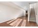 Sunlit living room with hardwood floors and staircase at 3735 Kalamath St # 3, Denver, CO 80211