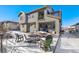 Spacious backyard with patio furniture and snowy landscape at 16382 Spanish Peak Way, Broomfield, CO 80023