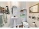 Charming bathroom with pedestal sink, toilet, and decorative accents at 16382 Spanish Peak Way, Broomfield, CO 80023