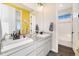 Bathroom with double sinks, granite countertop, and a tub at 16382 Spanish Peak Way, Broomfield, CO 80023