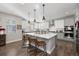 Modern kitchen with white cabinets, large island, and stainless steel appliances at 16382 Spanish Peak Way, Broomfield, CO 80023