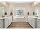 Main bathroom with double vanity, soaking tub, and walk-in shower at 16382 Spanish Peak Way, Broomfield, CO 80023