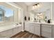 Main bathroom with double vanity, soaking tub, and walk-in shower at 16382 Spanish Peak Way, Broomfield, CO 80023