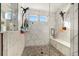 Spacious shower with double shower heads and built-in seating at 16382 Spanish Peak Way, Broomfield, CO 80023