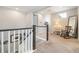 Upstairs hall with staircase, rocking chair, and mirror at 16382 Spanish Peak Way, Broomfield, CO 80023