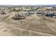 Aerial view of the extensive property with multiple buildings, a large field, and mature trees at 4900 Beverly Dr, Berthoud, CO 80513