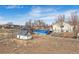 Backyard view with a chicken coop, swimming pool, shed, and deck at 4900 Beverly Dr, Berthoud, CO 80513