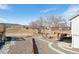 Backyard view of multi-level wooden decks, a firepit and seating area, a hammock, and an open field at 4900 Beverly Dr, Berthoud, CO 80513