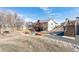 Large wooden deck overlooking the backyard with colorful Adirondack chairs surrounding a gravel firepit area at 4900 Beverly Dr, Berthoud, CO 80513